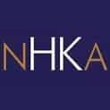 Logo with the letters "NHKA" in white and brown on a dark blue background.