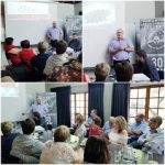 A man gives a presentation to a seated audience in a room with a projector screen and banners, captured from multiple angles.
