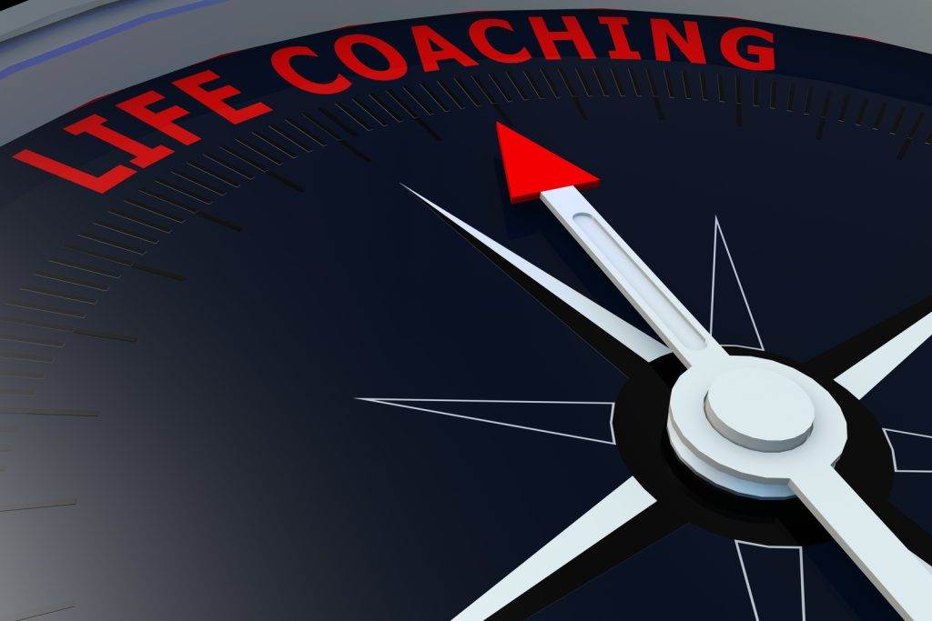 Compass needle pointing to "Life Coaching" in bold red letters, symbolizing guidance and direction in personal development.