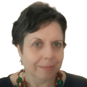 Portrait of Marna van den Berg with short dark hair, wearing a colorful beaded necklace, and smiling slightly at the camera.