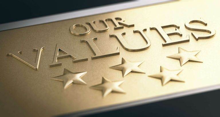 Gold plaque with the embossed words "Our Values" and five stars underneath.