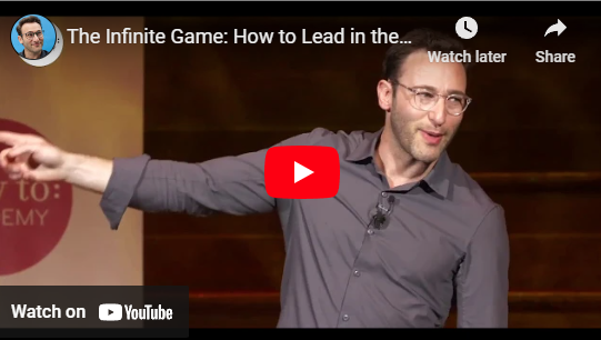 Speaker presenting "The Infinite Game" concept on leadership, gesturing on stage, captured in a YouTube video thumbnail.