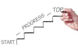 Hand drawing stairs labeled Start, Progress, Top, illustrating career coaching vs career counselling pathways.