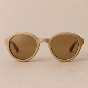 Brown round sunglasses on beige background, representing Enneagram Lens type 9.