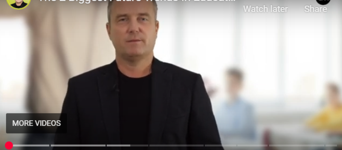 Thumbnail of a man presenting on future trends in education, with blurred classroom background. Rethinking education focus.